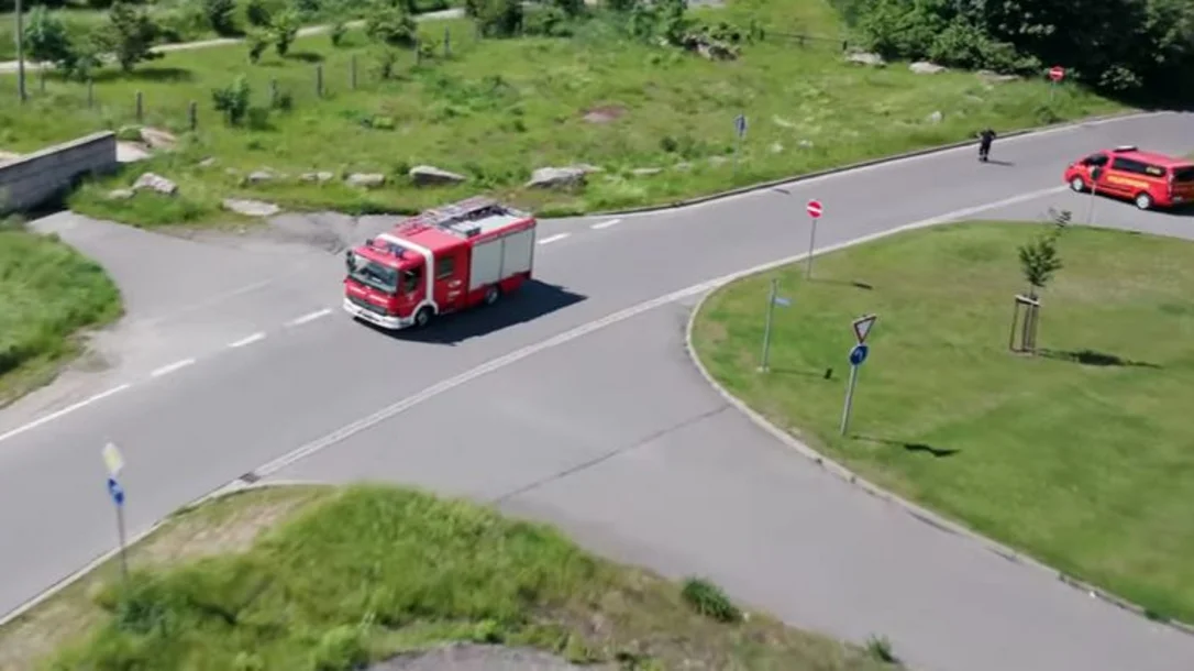 Ein Feuerwehrwagen fährt über eine Landstraße