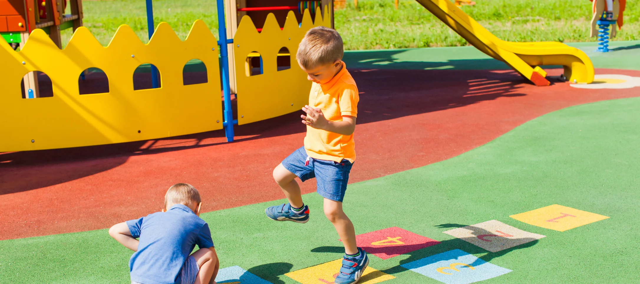 Zwei Kinder spielen Hüpfkästchen
