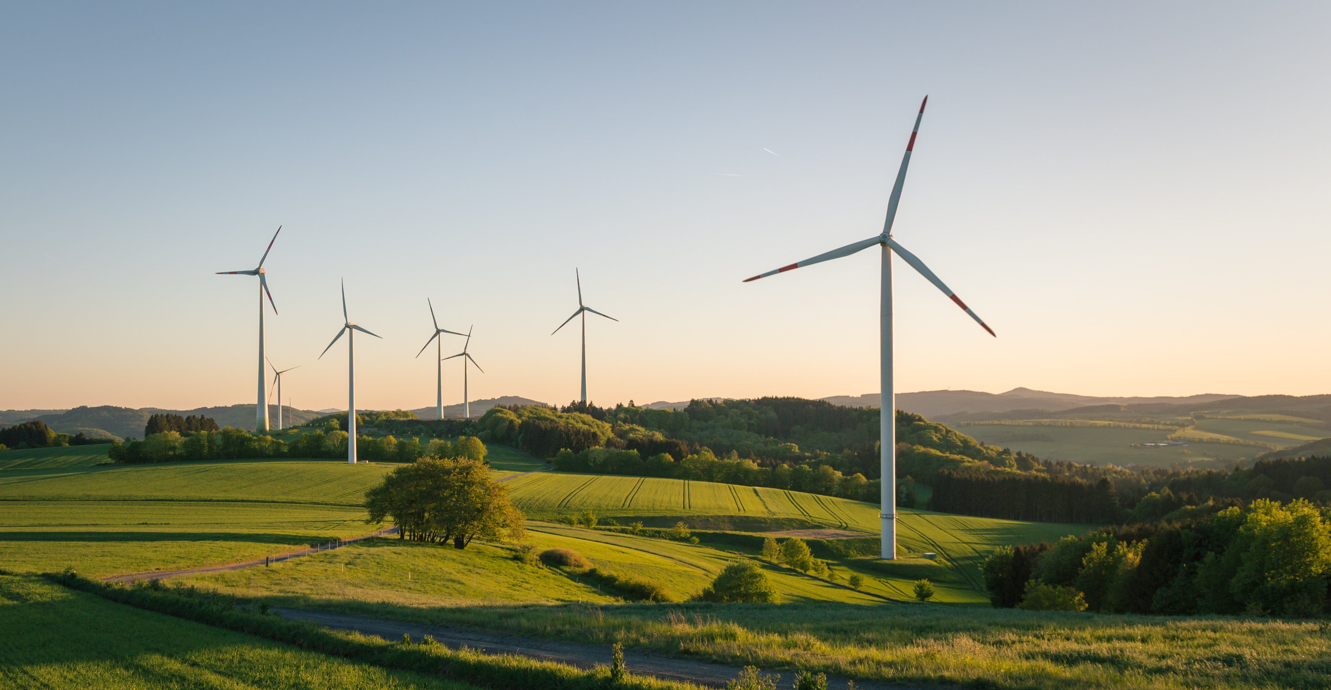 Mehrere Windkraftanlagen im Sonnenuntergang